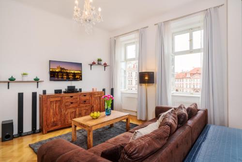 a living room with a couch and a tv at Old Town Square Premium Residence in Prague