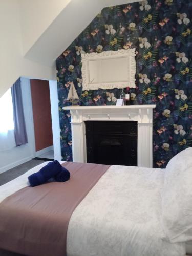 a bedroom with a bed with a fireplace and a fire place at Easkey Hostel in Sligo