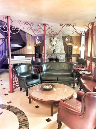a living room with leather chairs and a table at Frapolli Hotel on Deribasivska street in Odesa