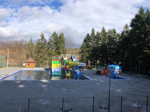 a playground with a water slide in a parking lot at Saltzbork in Staraya Solʼ
