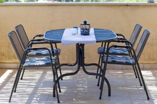 a blue table with chairs and a cup on it at ARGUSA4 in Makarska