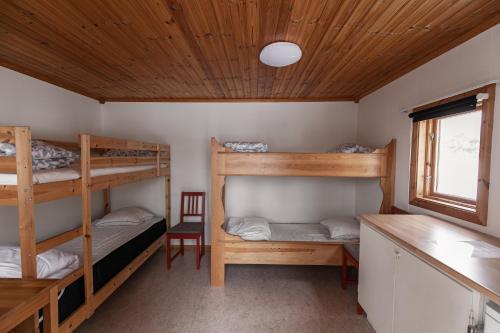 a room with two bunk beds and a desk at Vansbro Camping in Vansbro