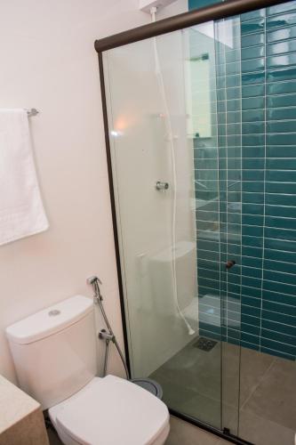 a bathroom with a toilet and a glass shower at POUSADA ESTÂNCIA in Penedo