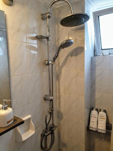 a shower with a shower head in a bathroom at City House 3 in Kalamata