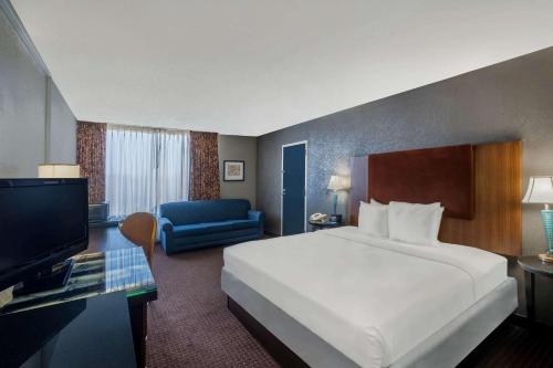 a hotel room with a bed and a television at Travelodge by Wyndham Memphis Airport/Graceland in Memphis