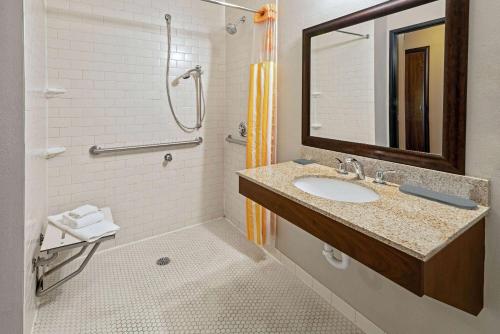 a bathroom with a sink and a shower and a mirror at La Quinta by Wyndham Butte in Butte