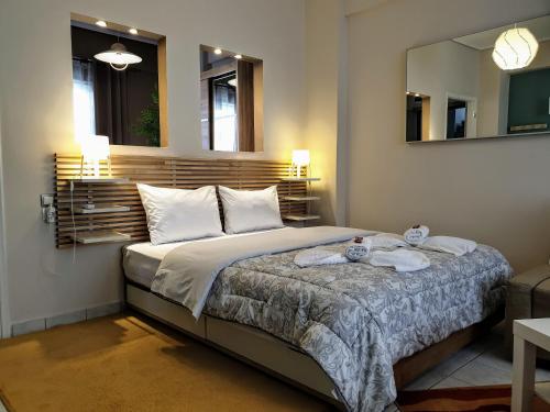 a bedroom with a bed with two towels on it at City House 3 in Kalamata