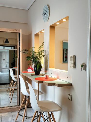 a kitchen with a table and chairs and a mirror at City House 3 in Kalamata
