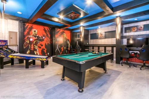 a game room with a pool table and a mural at 2911 Fable Street in Kissimmee