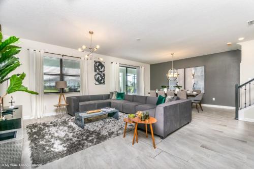 a living room with a gray couch and a table at 2911 Fable Street in Kissimmee