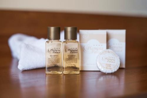 two bottles of essential oils sitting on a table at Hotel Plamena Palace in Primorsko