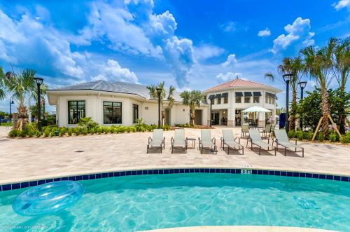 a villa with a swimming pool and a house at 4814 Lullaby Lane in Kissimmee
