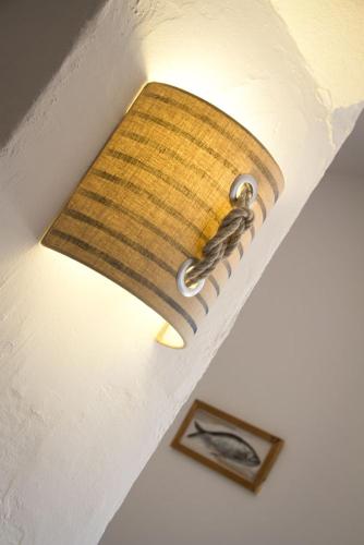 a light on a ceiling with a light on it at Hôtel Le Vert Bois in Dolus d'Oléron