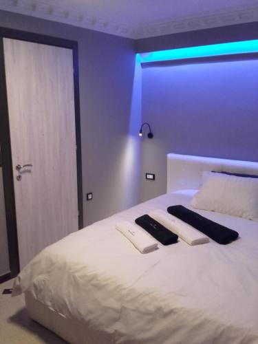 a bedroom with a white bed with two towels on it at Pietra Mare Suites in Patra
