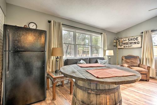 a living room with a table and a refrigerator at Studio with Patio - Walk to Hikes, Sights and Bites in Aberdeen