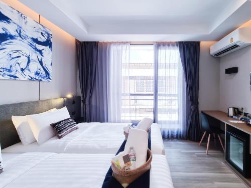 Ένα ή περισσότερα κρεβάτια σε δωμάτιο στο SOVA Hotel Bangkok