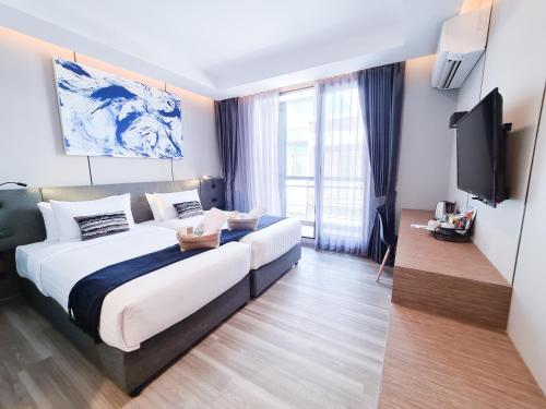 Posteľ alebo postele v izbe v ubytovaní SOVA Hotel Bangkok