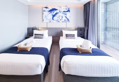 Ένα ή περισσότερα κρεβάτια σε δωμάτιο στο SOVA Hotel Bangkok