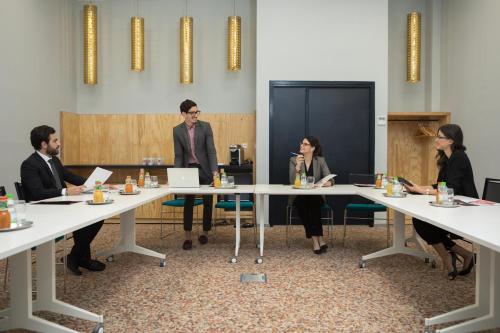 a group of people sitting around a table in a room at Ibis Abdelmoumen Casa Centre in Casablanca