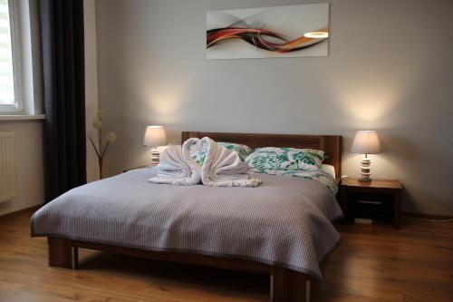 a bedroom with a bed with towels on it at Apartament Ania in Jelenia Góra