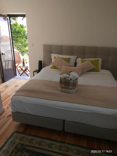 a bedroom with a large bed with pillows at Oporto Glamour Suite House in Vila Nova de Gaia