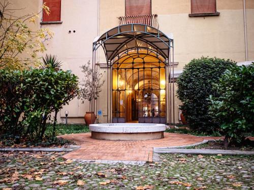 um edifício com um banco em frente a uma porta em Atelier Pallavicini Suites em Bolonha