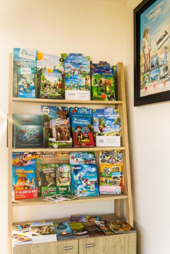 a book shelf filled with games and books at initial by balladins La Roche-sur-Yon in La Roche-sur-Yon