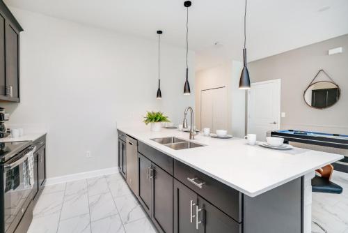 a kitchen with a sink and a counter at Beautiful Modern Home wPrivate Pool Near WDW in Kissimmee