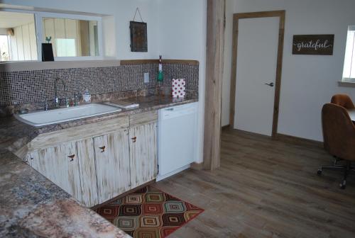 a kitchen with a sink and a counter at Dora's Country Cottage in Escalante