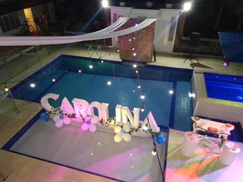 a swimming pool with a sign that says reunion at Casa Quinta Santana in Melgar