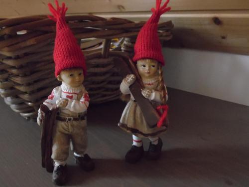 two dolls wearing red hats standing next to each other at Chalet des Clarines in Saint-Genès-Champespe