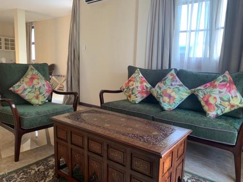a living room with a couch and a coffee table at Viluveli Holiday Retreat in Hanimaadhoo