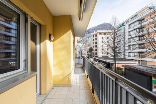 a balcony with a view of a city at Lido Apartments by Quokka 360 - 5 min from the centre and the Lugano Lido in Lugano