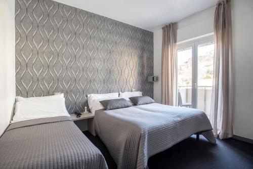 Postel nebo postele na pokoji v ubytování Hotel Rubino