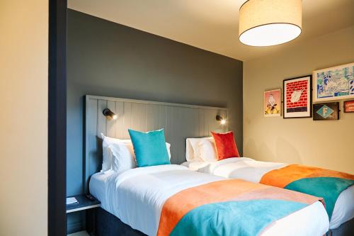 two beds sitting next to each other in a room at Firefly in Bray