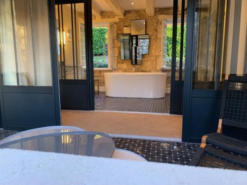 a bathroom with a tub in the middle of a building at Le Moulin du Roc in Brantôme