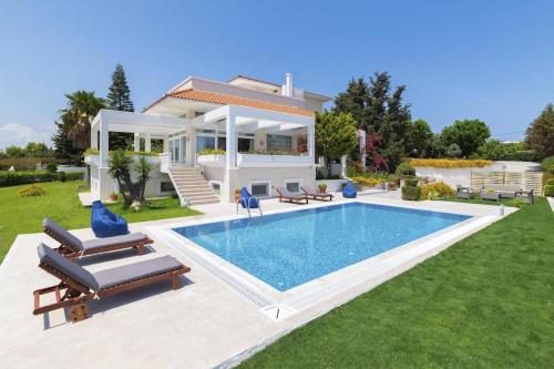 a villa with a swimming pool in front of a house at City Mansion Rhodes in Rhodes Town