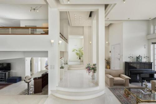 a large living room with white walls and columns at City Mansion Rhodes in Rhodes Town