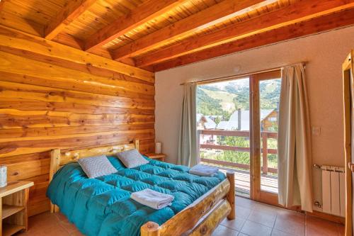 a bedroom with a bed and a large window at Punto Bariloche in San Carlos de Bariloche