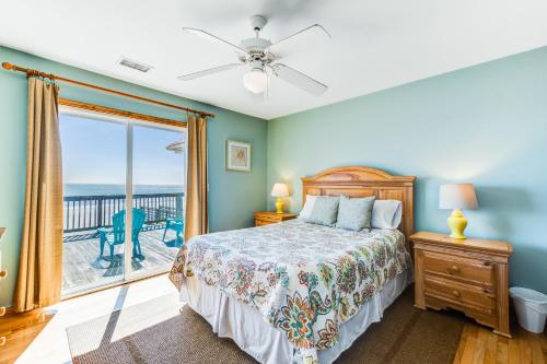 a bedroom with a bed and a view of the ocean at Turtle Watch II in Folly Beach