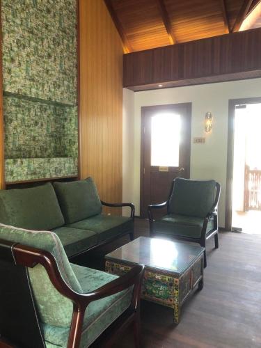 a living room with two couches and a coffee table at Viluveli Holiday Retreat in Hanimaadhoo