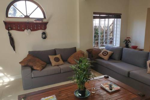 a living room with a couch and a table at The Blue Horizon House - Botrivier in Caledon