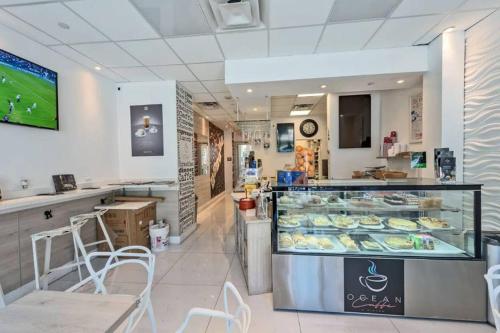 a bakery with a display case in a store at Beautiful Apartment Steps Away from the Beach in Miami Beach