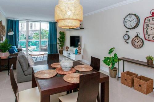 a living room with a table and a dining room at Beautiful Apartment Steps Away from the Beach in Miami Beach