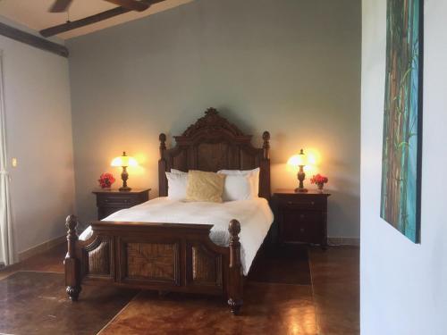 a bedroom with a bed and a lamp at Almond Tree Hotel Resort in Corozal