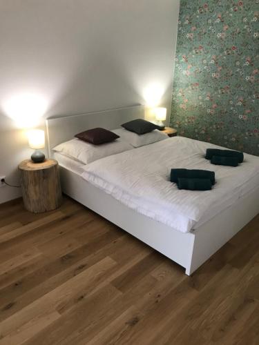 a bedroom with a large white bed with two pillows at Ubytování Zahrada in Mutěnice