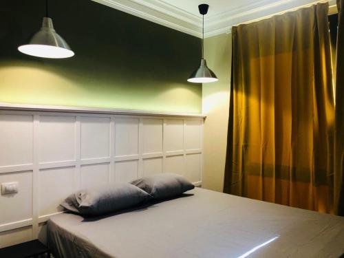 a bedroom with a bed with two pillows on it at Sodic Westown Residence1-near Elnada hospital in ‘Izbat Yūsif Barrādah