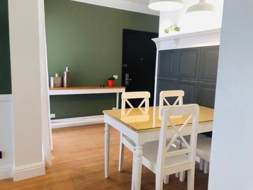 a dining room with a table and two chairs at Sodic Westown Residence1-near Elnada hospital in ‘Izbat Yūsif Barrādah