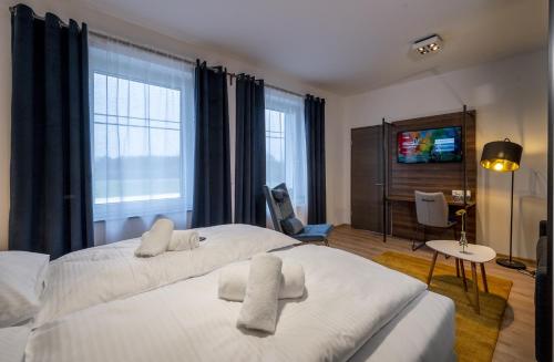 a bedroom with a large bed with two towels on it at Hotel Zu Freunden in Hamm
