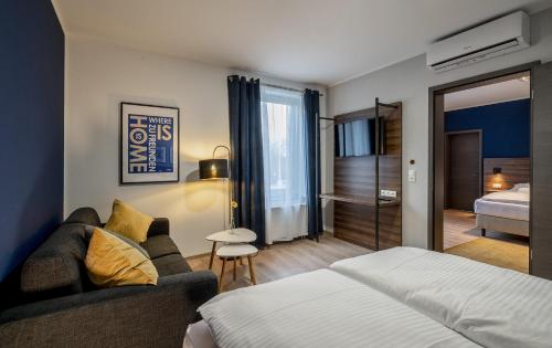 a hotel room with a bed and a couch at Hotel Zu Freunden in Hamm